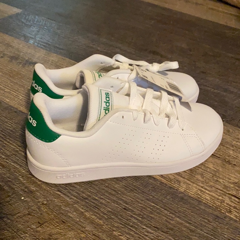 White and green adidas children’s tennis shoes